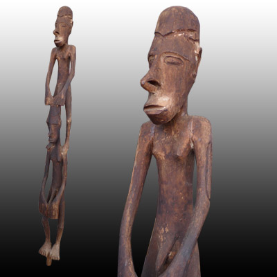 Asmat double canoe sculpture showing two male figures 