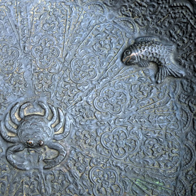 Minangkabau bronze plate with floral motives and impressed with three fishes and a crab